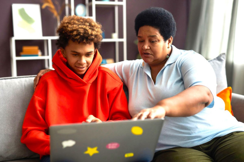 Mother and son looking at a laptop 