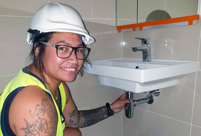 Raukawa Paama fixes a bathroom sink
