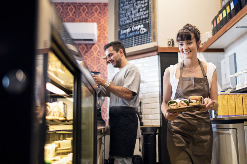 Two cafe workers behind the counter